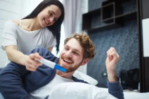 the happy couple with the pregnancy test